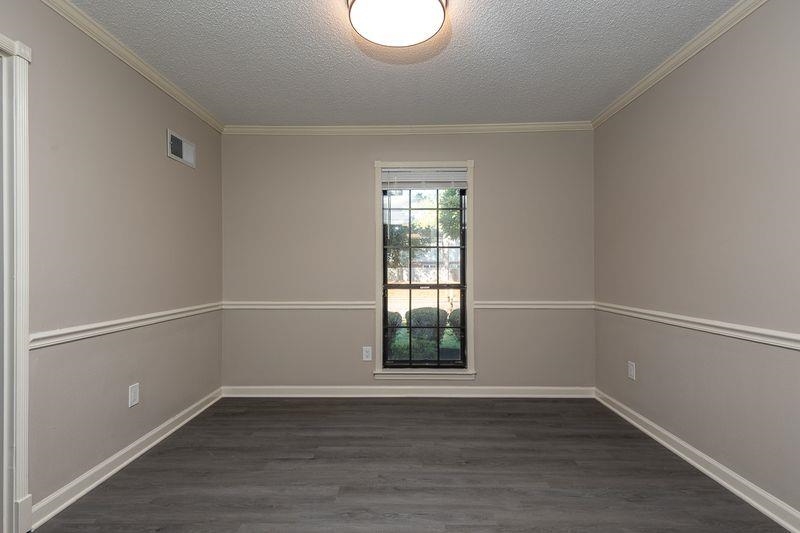 1780 Allenby Road Germantown, TN 38139 - Photo 6 of 26 a view of an empty room with wooden floor and a window