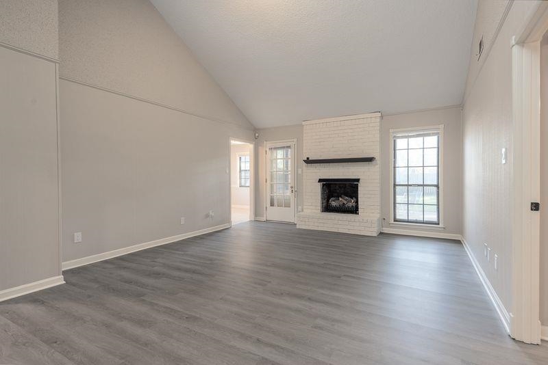 1780 Allenby Road Germantown, TN 38139 - Photo 7 of 26 an empty room with wooden floor fireplace and windows