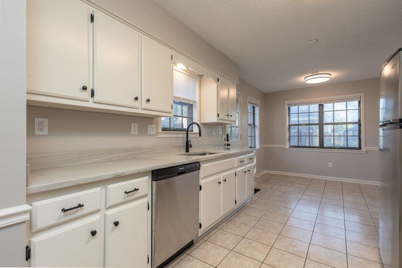 1780 Allenby Road Germantown, TN 38139 - Photo 10 of 26 a kitchen with granite countertop a sink and cabinets