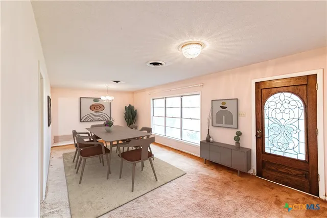 a view of a dining room with furniture window and outside view