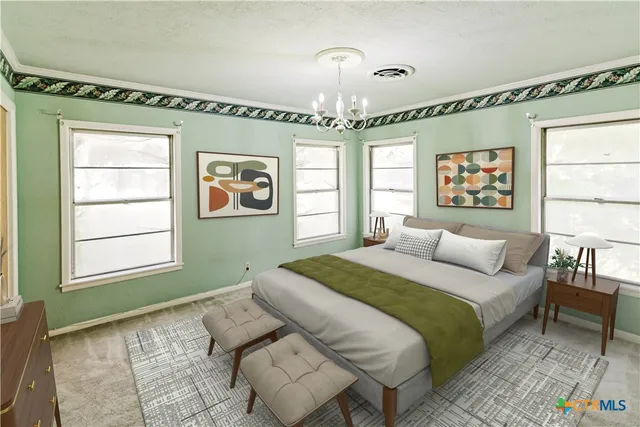 a spacious bedroom with a bed and a window