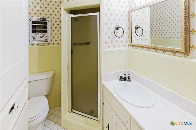 a bathroom with a sink a toilet and shower curtain
