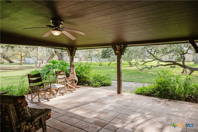 a view of a porch with furniture and garden