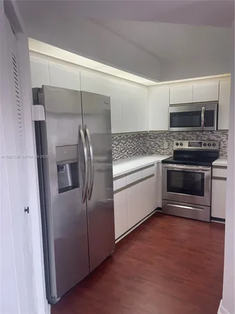 a kitchen with stainless steel appliances granite countertop a stove and a refrigerator