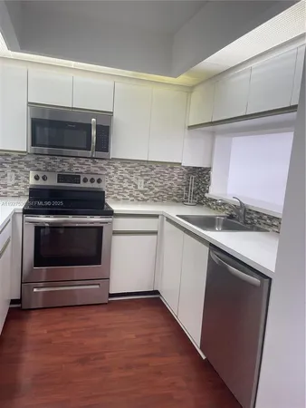 a kitchen with a stove and a microwave