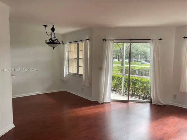 a view of room with window and hardwood floor