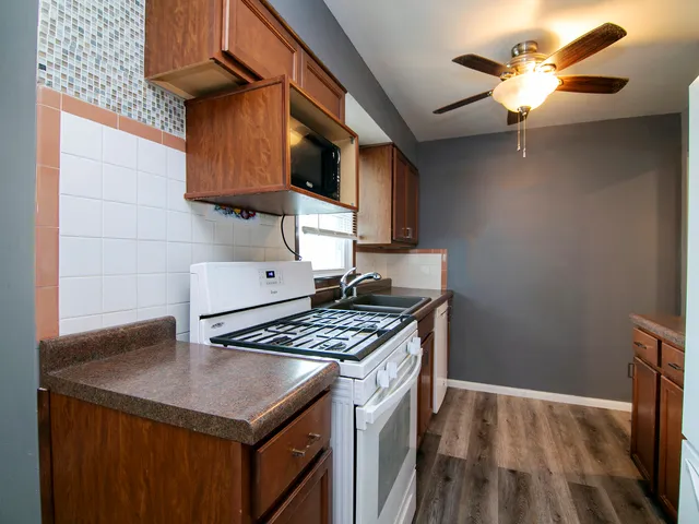 a kitchen with a sink a stove and cabinets
