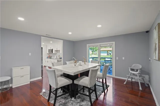 a view of a dining room with furniture window and wooden floor