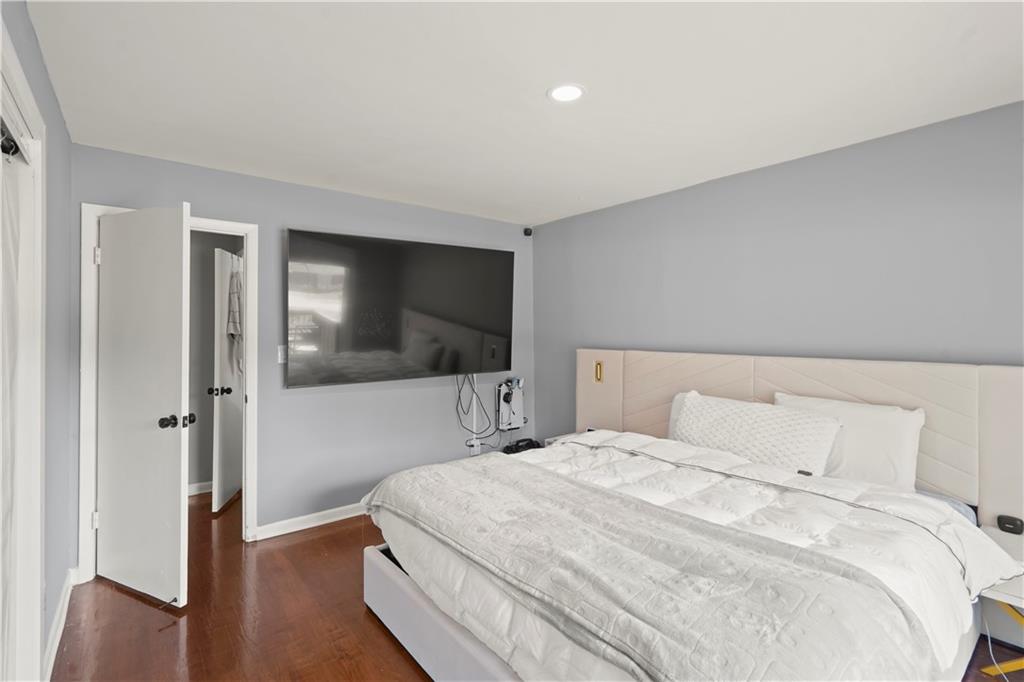 4166 Idlevale Drive Tucker, GA 30084 - Photo 27 of 36 a bedroom with a bed and a flat screen tv