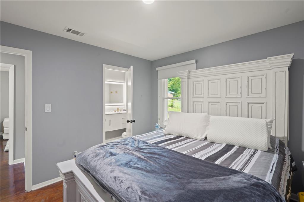 4166 Idlevale Drive Tucker, GA 30084 - Photo 31 of 36 a bedroom with a bed and wooden floor