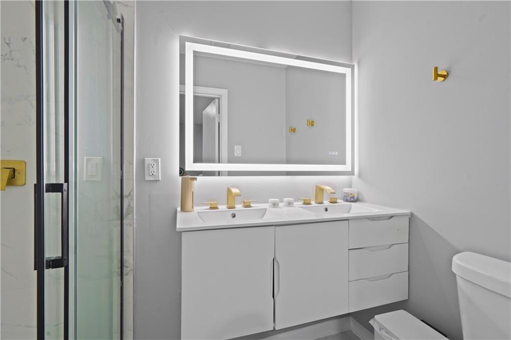 4166 Idlevale Drive Tucker, GA 30084 - Photo 32 of 36 a bathroom with a toilet sink and mirror