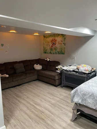 a living room with furniture and painting on the wall