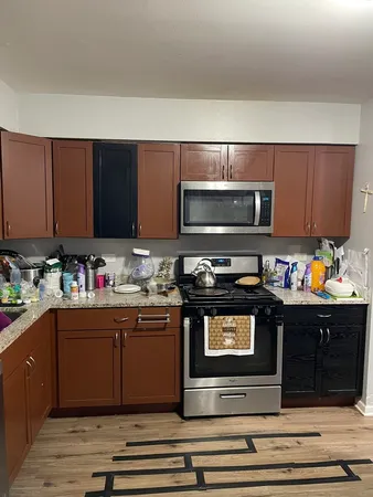 a kitchen with stainless steel appliances granite countertop a stove and a microwave