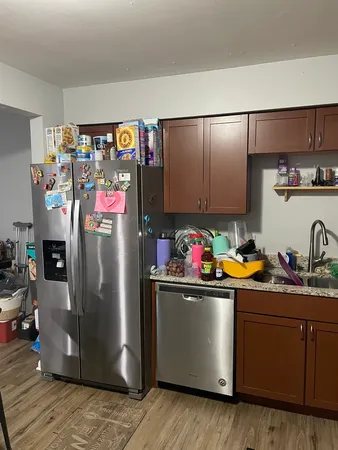 a kitchen with stainless steel appliances granite countertop a refrigerator and a sink
