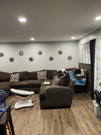 a living room with furniture and a wooden floor