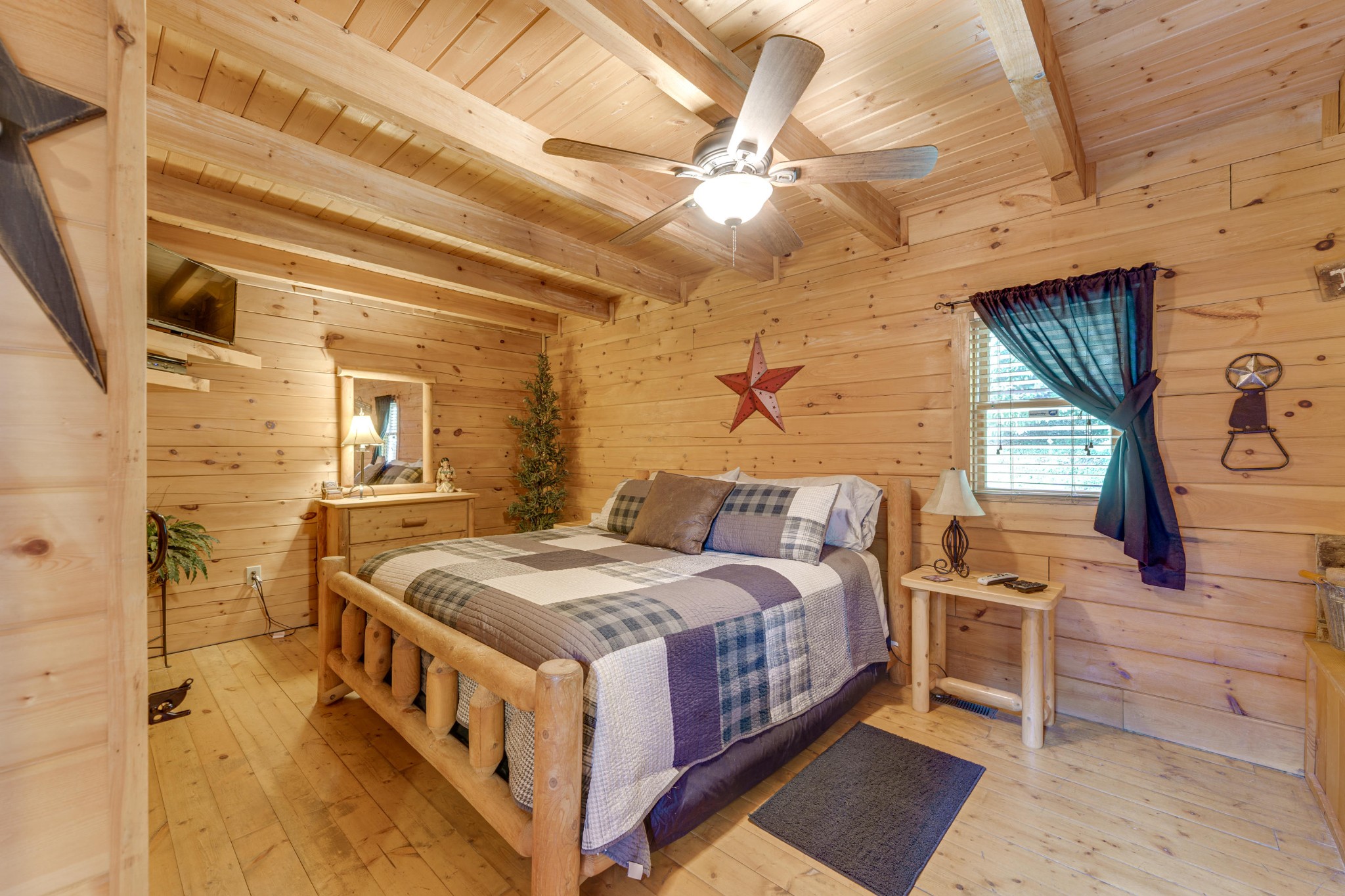 2740 Waldens Creek Road Sevierville, TN 37862 - Photo 23 of 40 a bedroom with a bed and a chandelier