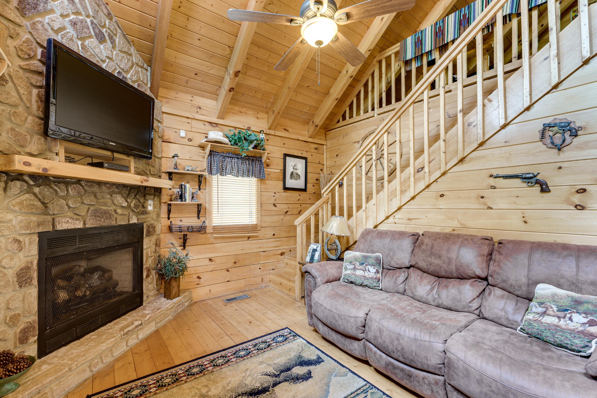2740 Waldens Creek Road Sevierville, TN 37862 - Photo 6 of 40 a living room with furniture a flat screen tv and a fireplace