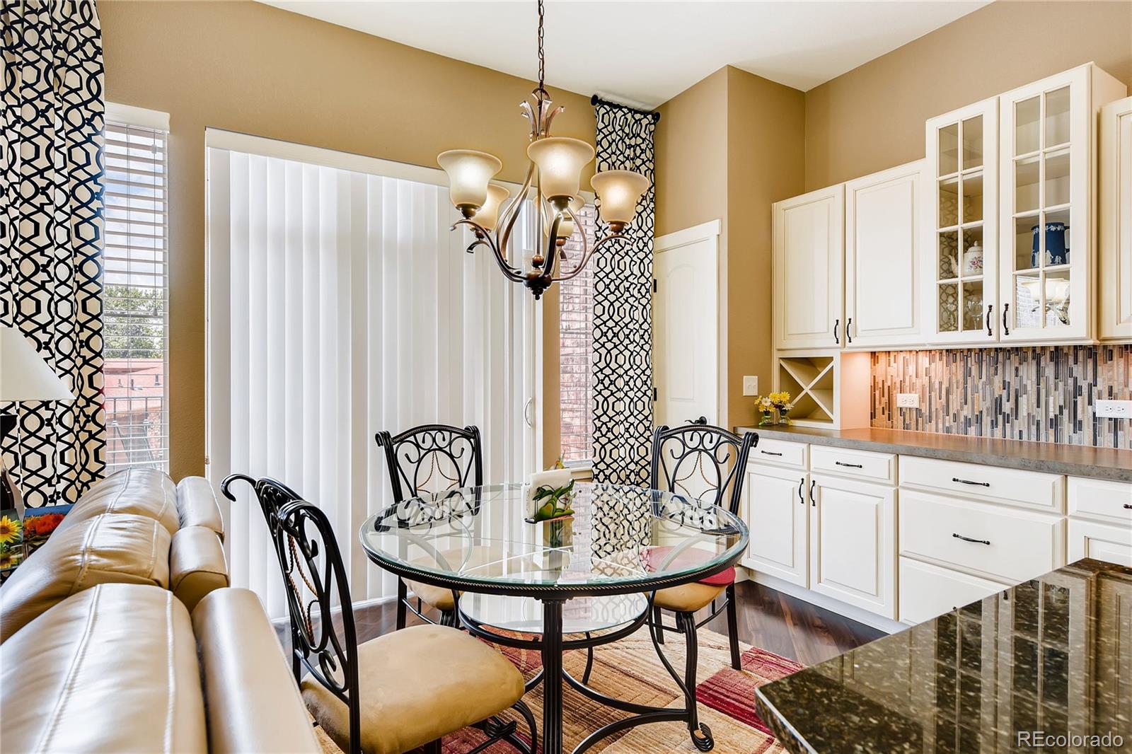 2366 Primo Road, Unit 205 Highlands Ranch, CO 80129 - Photo 9 of 28 a view of a dining room with furniture and chandelier