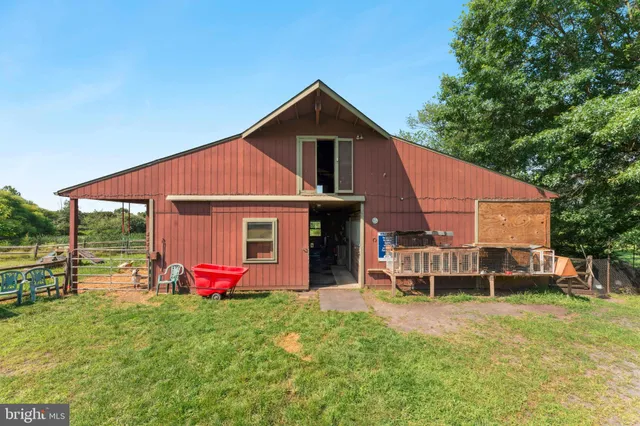 a view of a house with a yard patio and fire pit