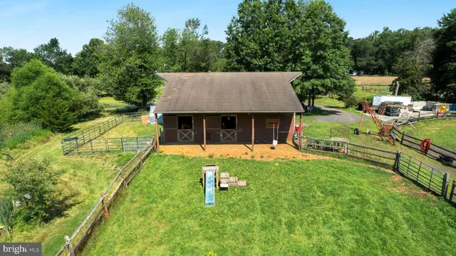 an aerial view of a house with swimming pool garden and patio