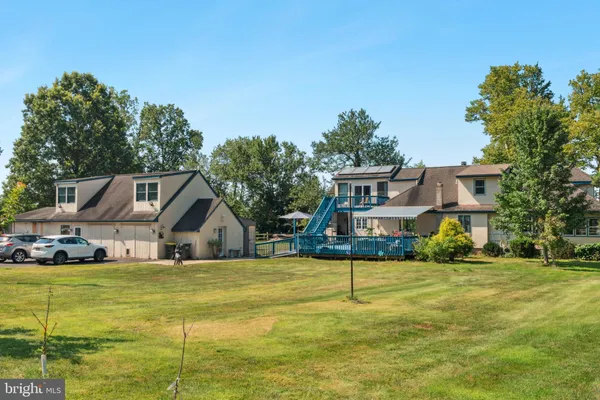 a view of house with outdoor space and swimming pool