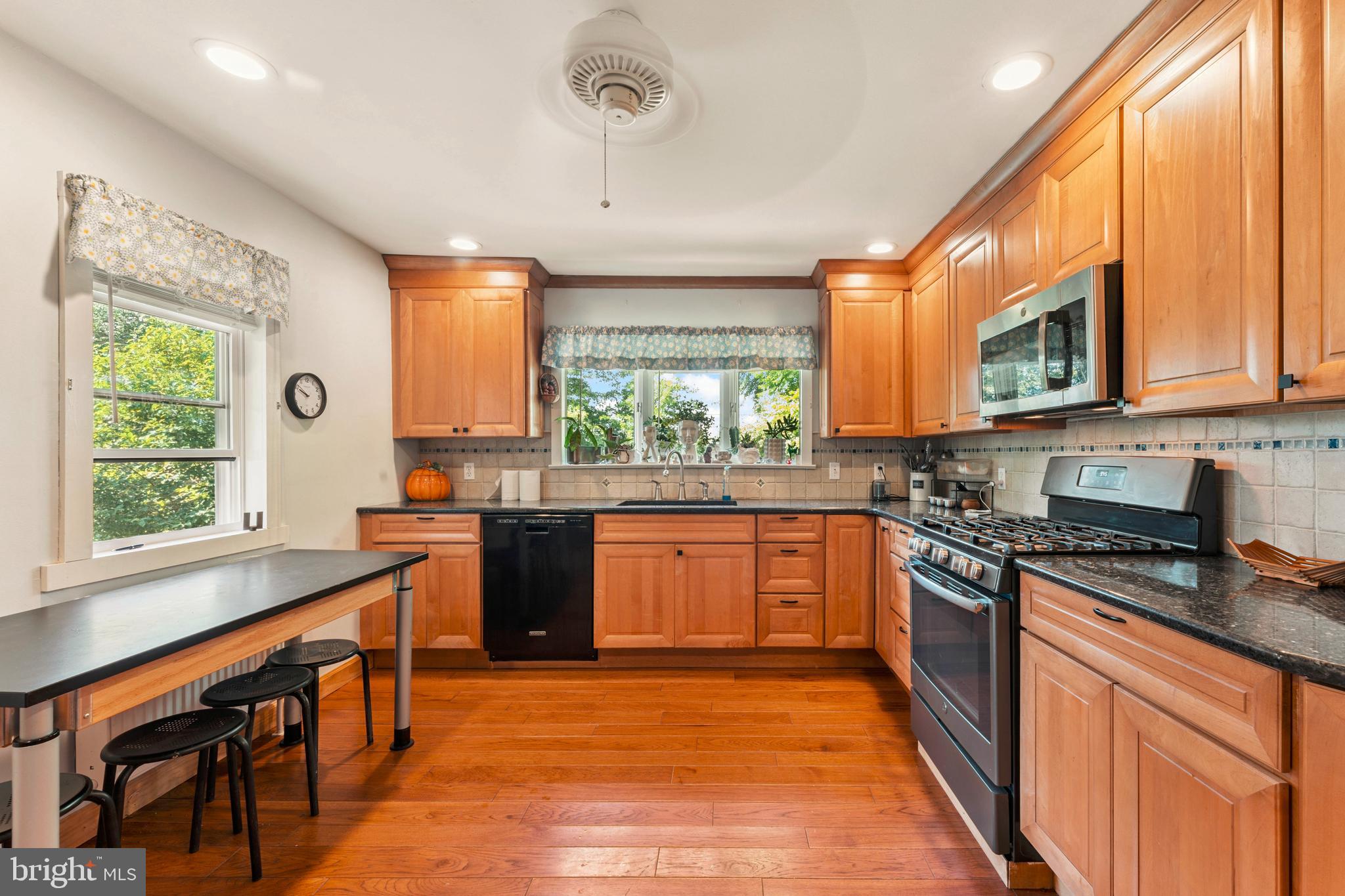 415 Geigel Hill Road Upper Black Eddy, PA 18972 - Photo 25 of 51 a kitchen with stainless steel appliances granite countertop sink stove top oven and cabinets
