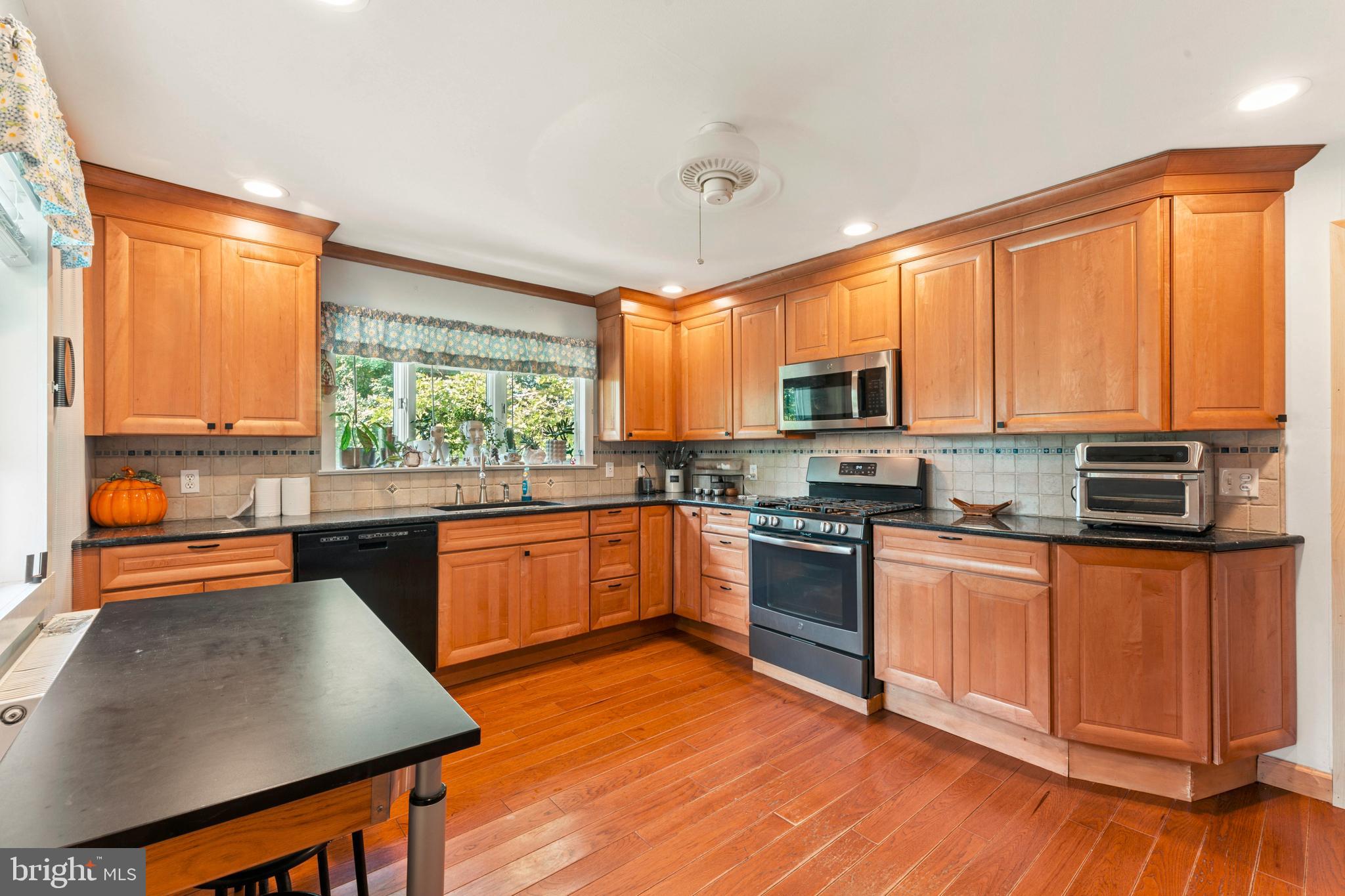 415 Geigel Hill Road Upper Black Eddy, PA 18972 - Photo 26 of 51 a kitchen with stainless steel appliances granite countertop a stove a sink and a microwave