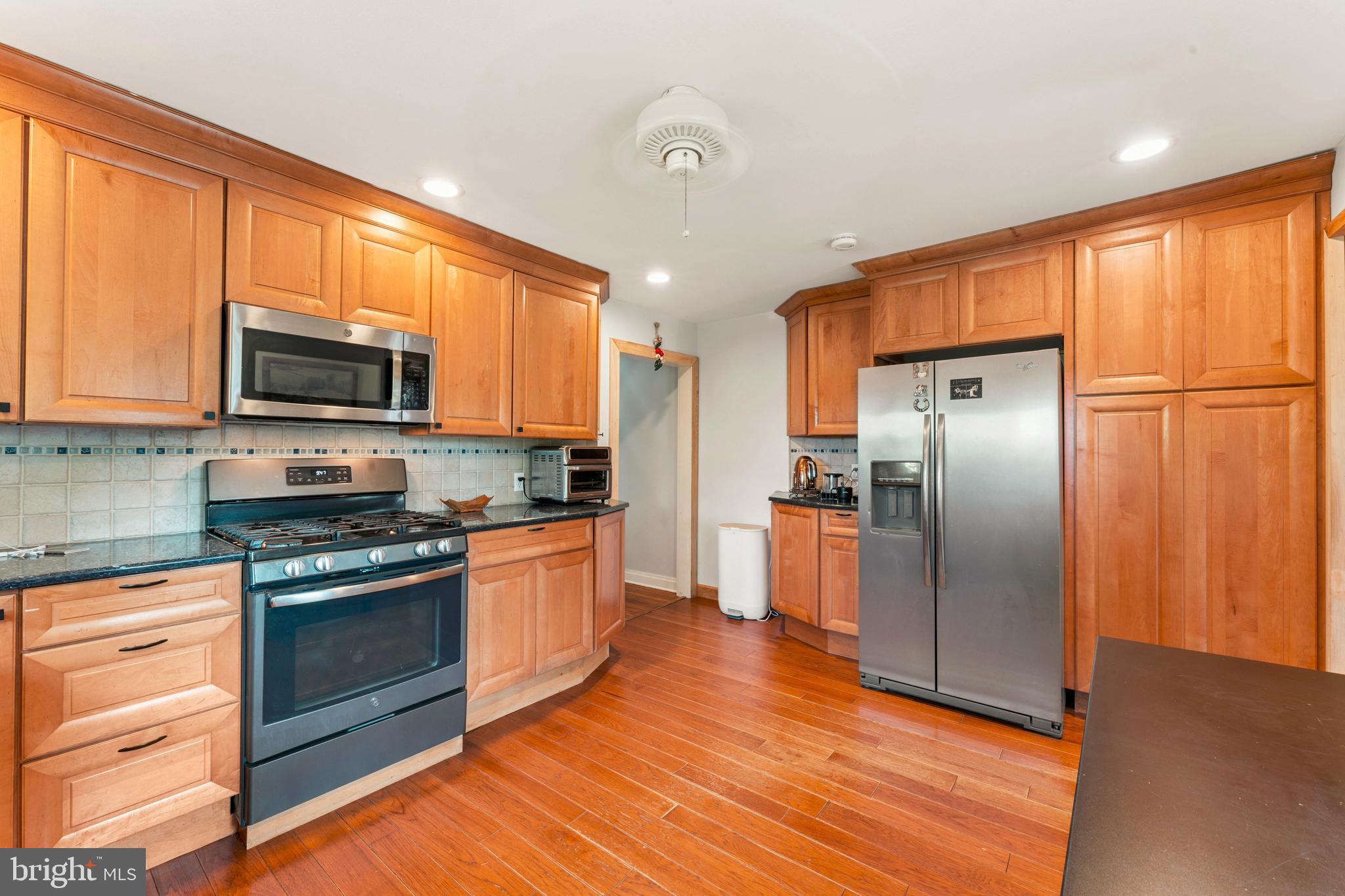 415 Geigel Hill Road Upper Black Eddy, PA 18972 - Photo 27 of 51 a kitchen with stainless steel appliances granite countertop a refrigerator a stove top oven a sink and dishwasher