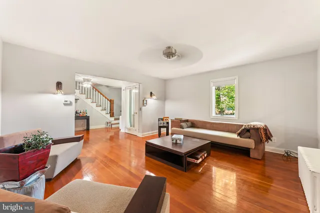 a view of a hallway with wooden floor and livingroom view