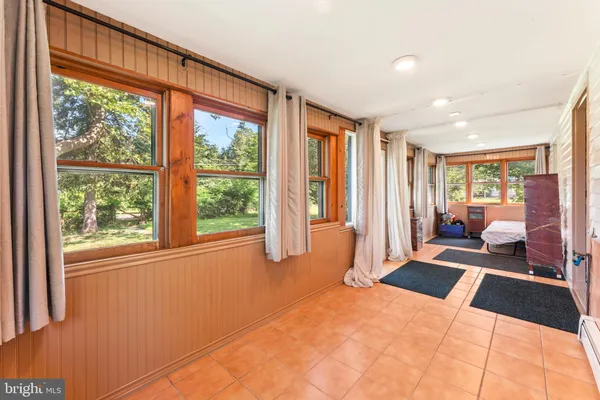 a bedroom with furniture and large windows