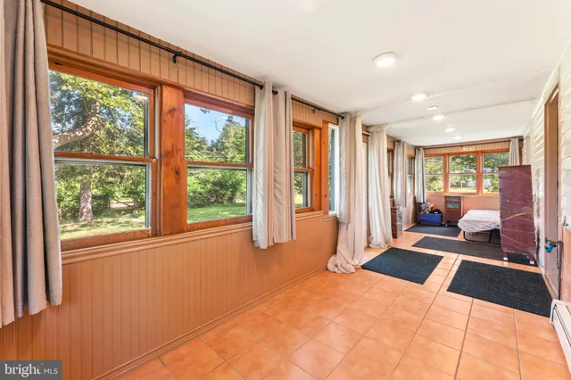 a bedroom with furniture and large windows