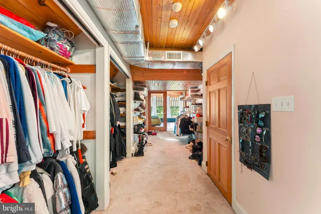 a bedroom with a bed and large window