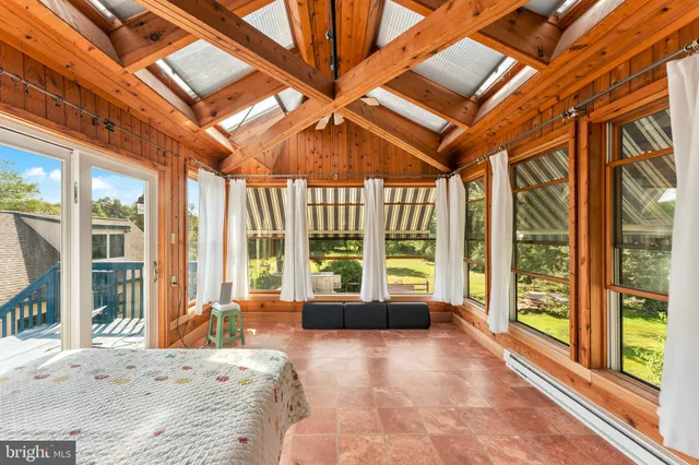 a bedroom with furniture and a window