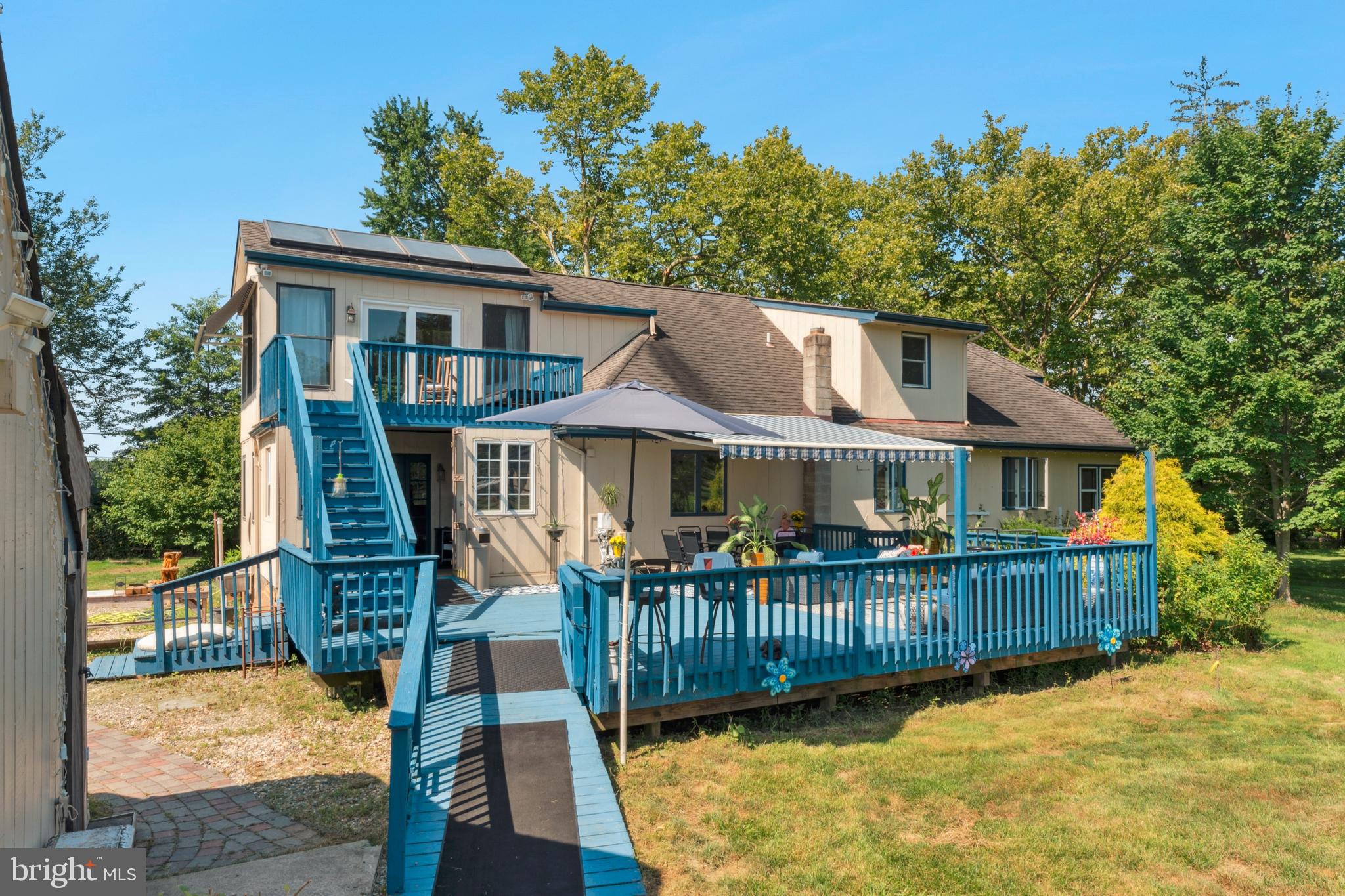 415 Geigel Hill Road Upper Black Eddy, PA 18972 - Photo 4 of 51 a front view of a house with a yard table and chairs