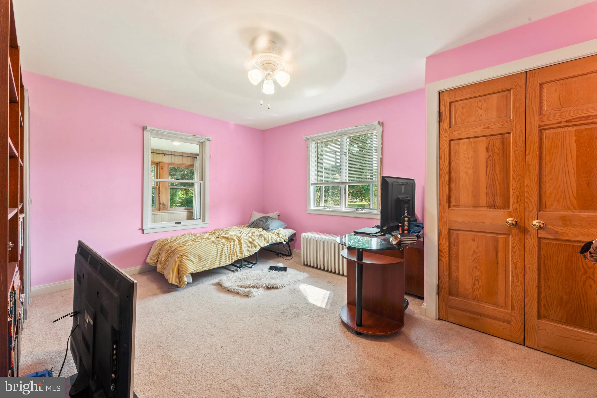 415 Geigel Hill Road Upper Black Eddy, PA 18972 - Photo 42 of 51 a bedroom with a bed and a chandelier
