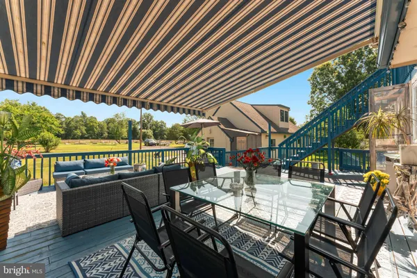 a view of balcony with wooden floor and seating space