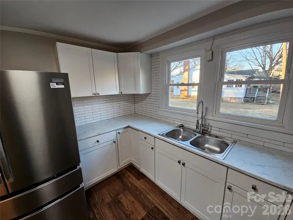 a kitchen with sink cabinets and window