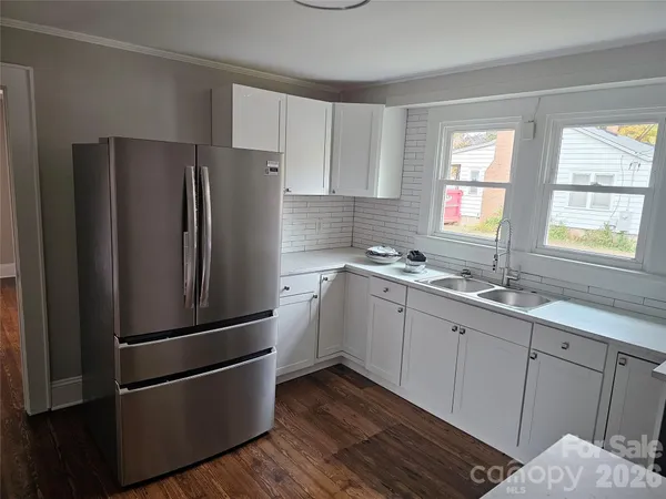 a kitchen with stainless steel appliances granite countertop a refrigerator sink and cabinets