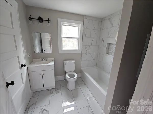 a bathroom with a toilet sink and shower