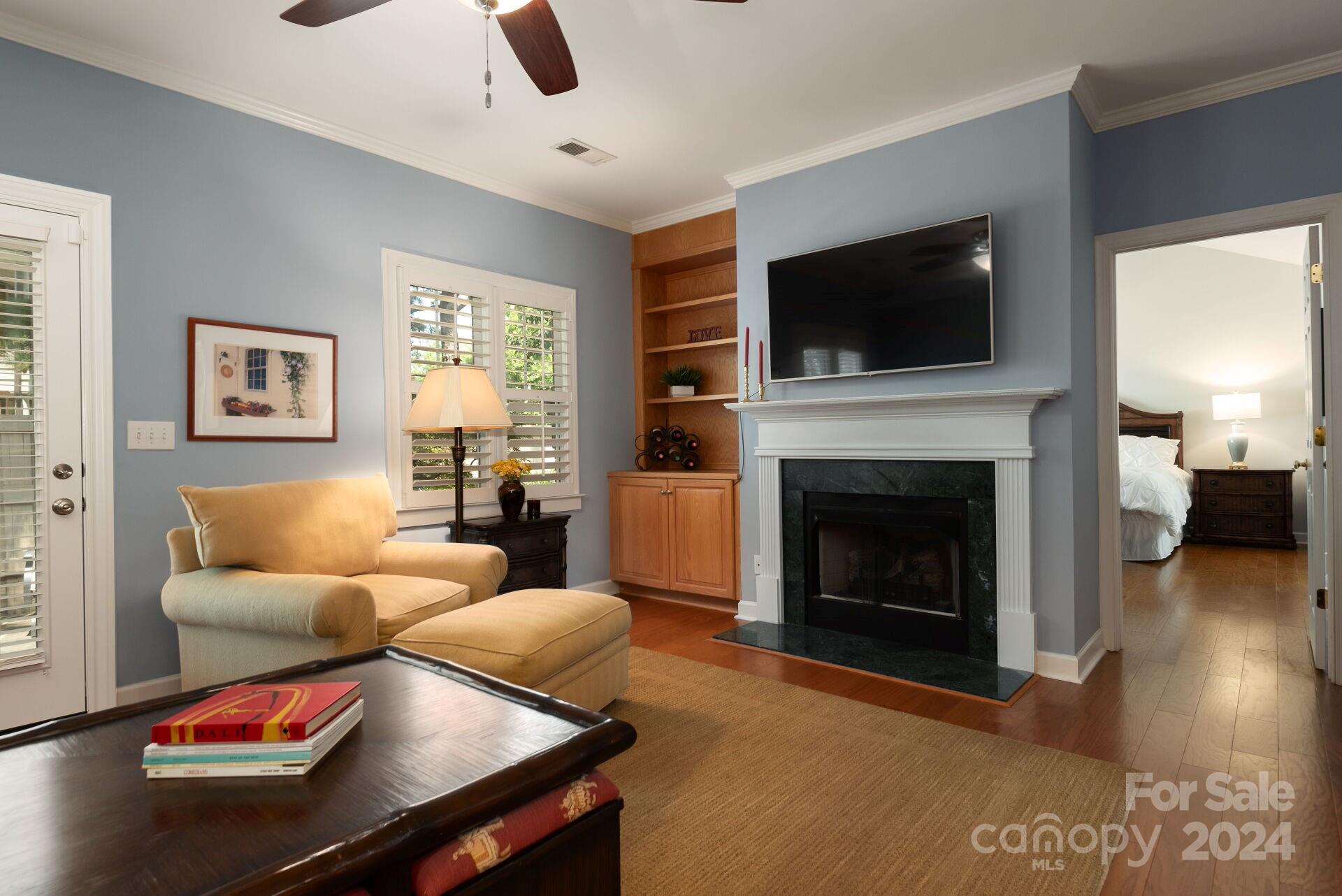 3322 Stettler View Road Charlotte, NC 28210 - Photo 11 of 27 a living room with furniture a flat screen tv and a fireplace