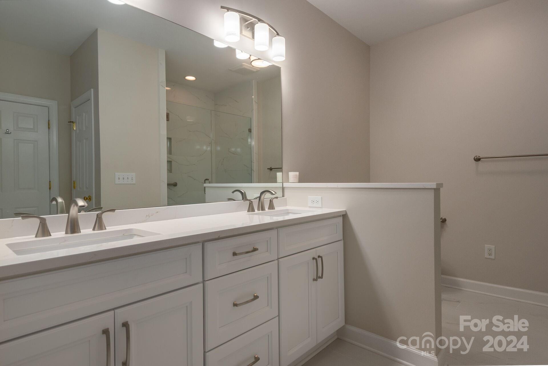 3322 Stettler View Road Charlotte, NC 28210 - Photo 14 of 27 a bathroom with a double vanity sink and a mirror