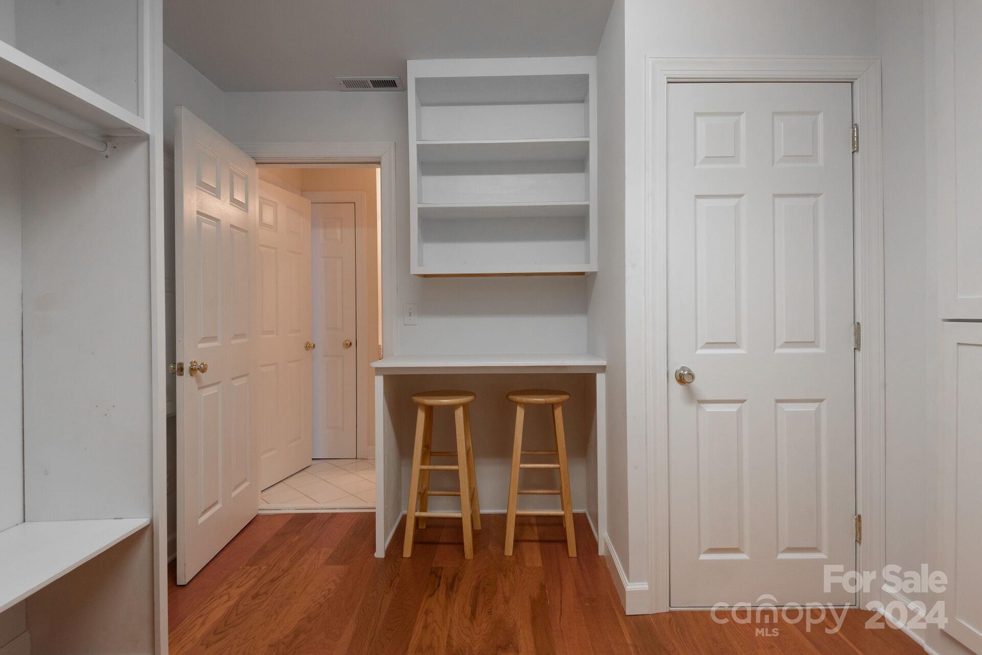 3322 Stettler View Road Charlotte, NC 28210 - Photo 21 of 27 a hallway with wooden floor a fireplace and entryway