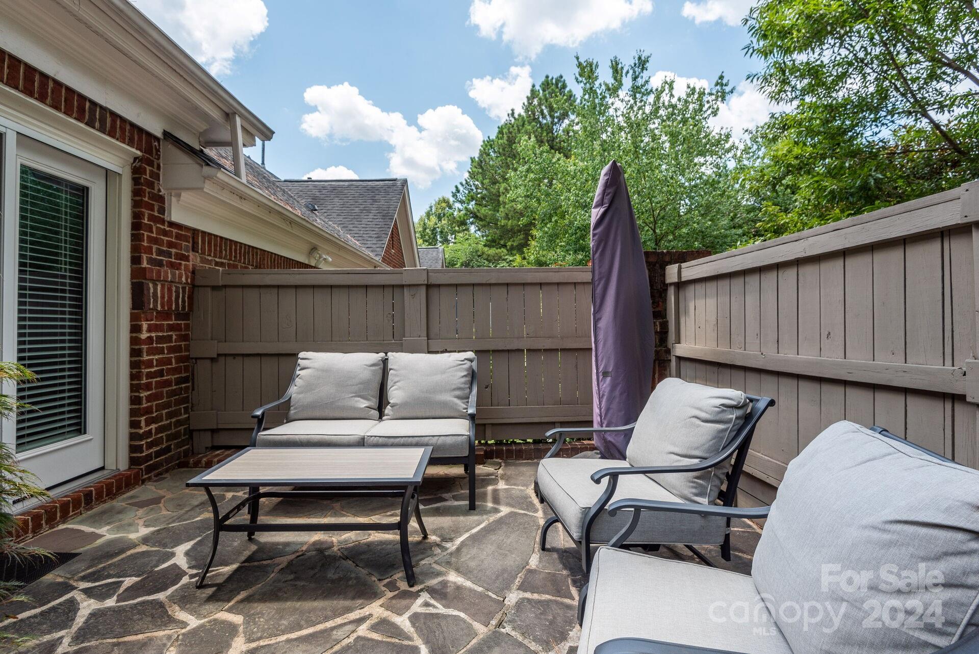 3322 Stettler View Road Charlotte, NC 28210 - Photo 24 of 27 a view of a patio with a table and chairs