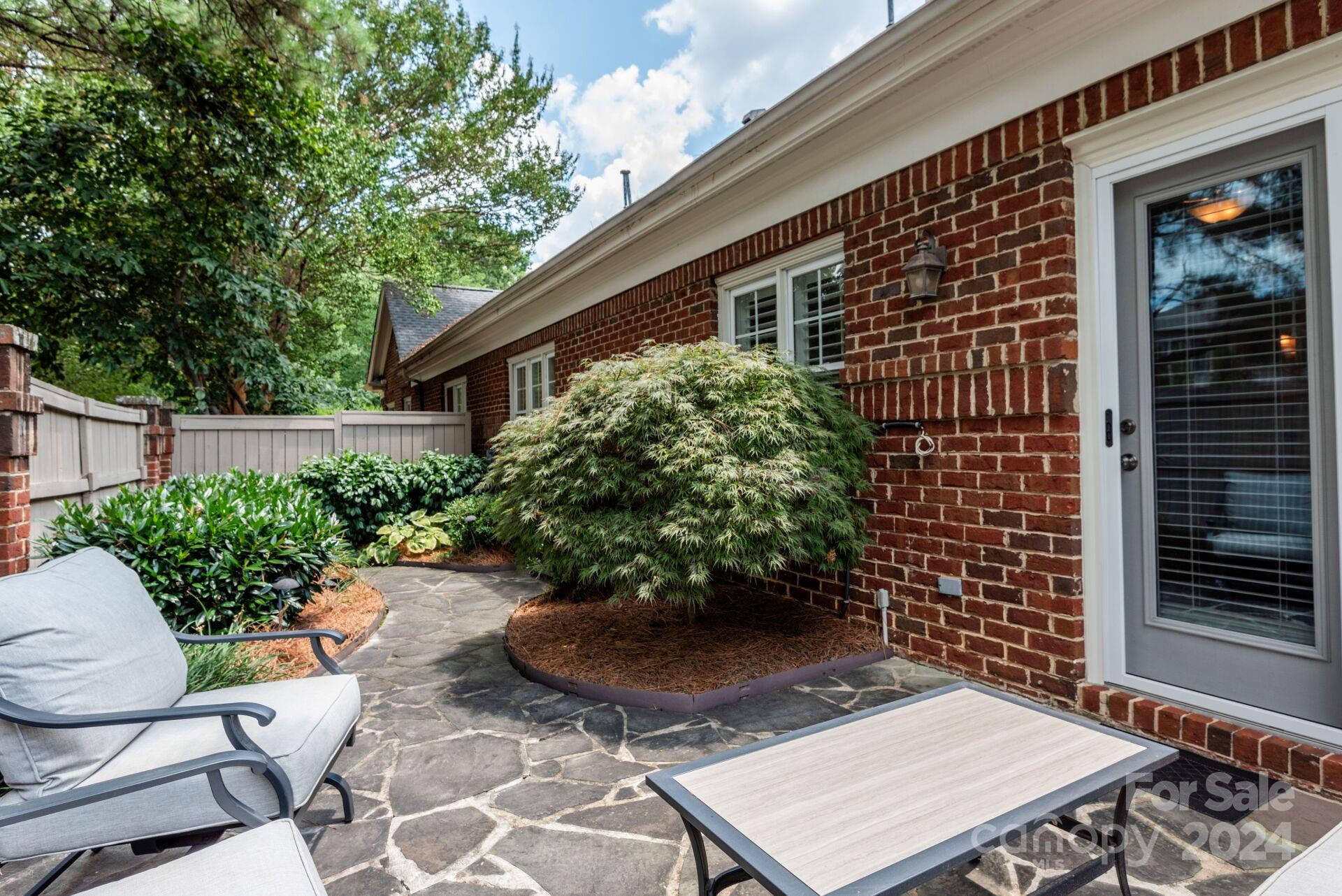 3322 Stettler View Road Charlotte, NC 28210 - Photo 25 of 27 a view of a backyard with plants and a patio
