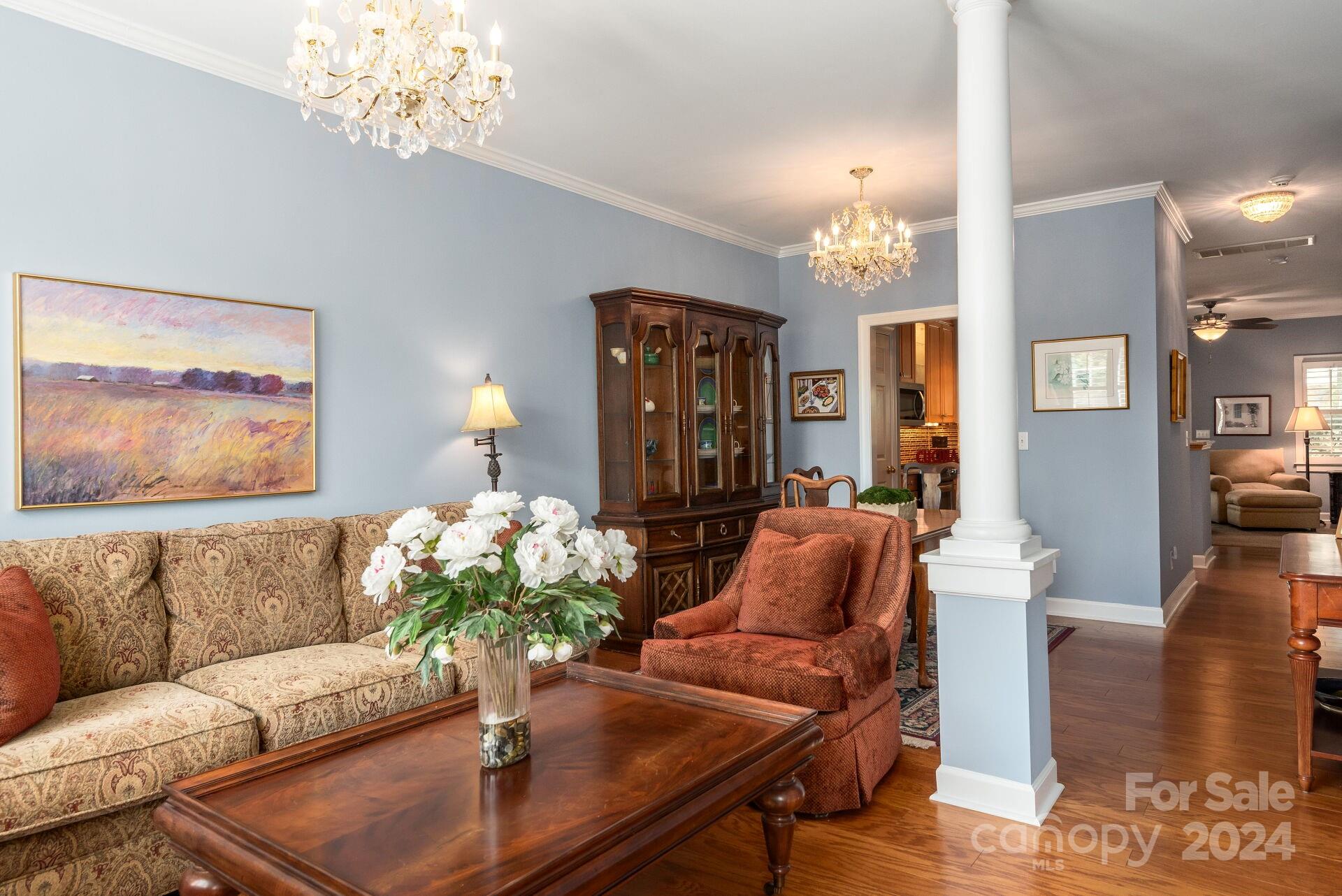 3322 Stettler View Road Charlotte, NC 28210 - Photo 3 of 27 a living room with furniture and a chandelier