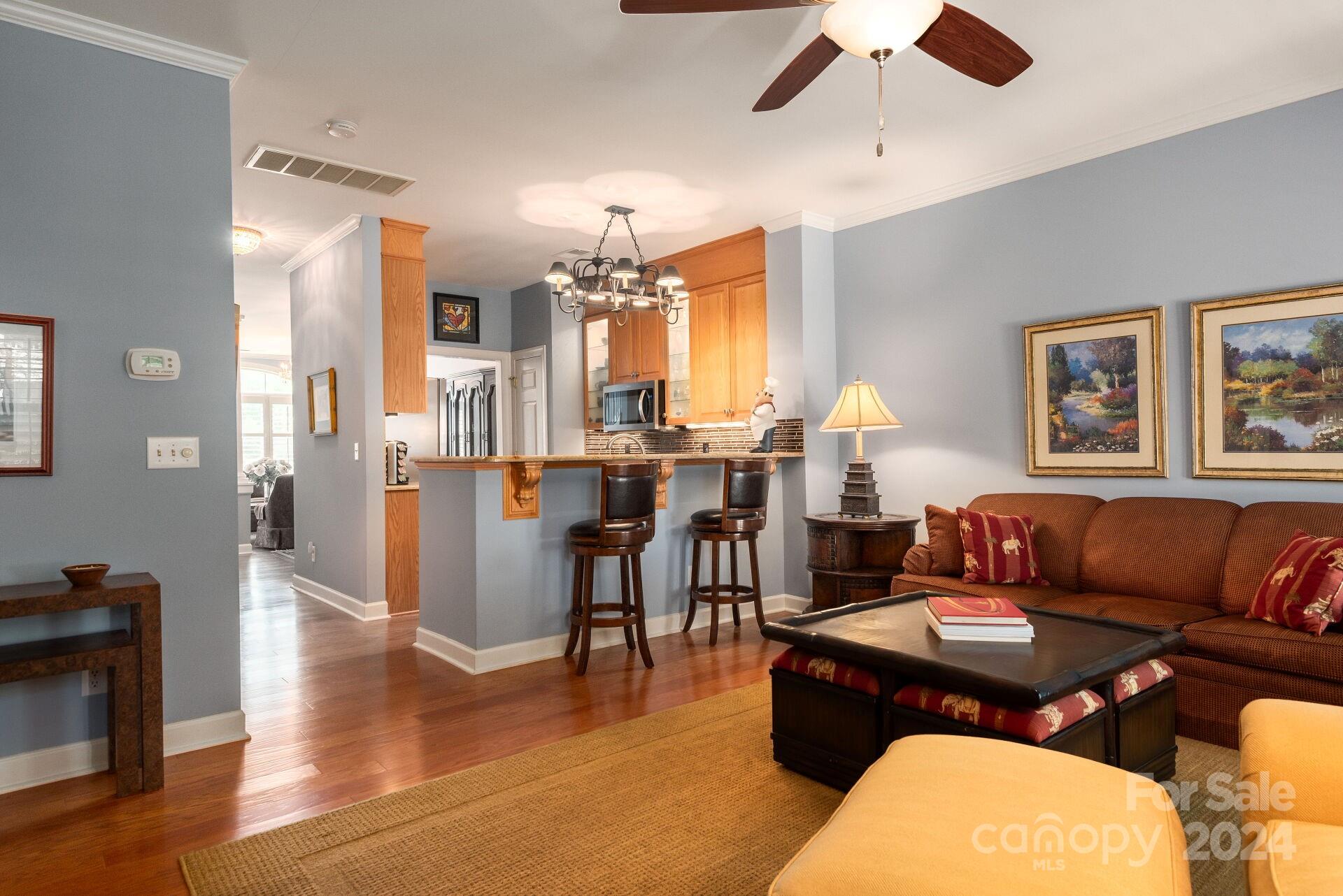 3322 Stettler View Road Charlotte, NC 28210 - Photo 9 of 27 a living room with furniture and a chandelier