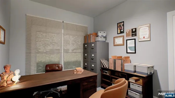 a view of a workspace with furniture and lamp