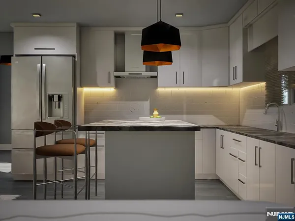 a kitchen with granite countertop a refrigerator a stove and a sink