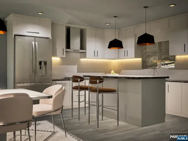 a kitchen with stainless steel appliances granite countertop a table chairs in it and wooden floors