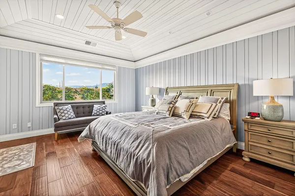 a bedroom with a bed lamp and window
